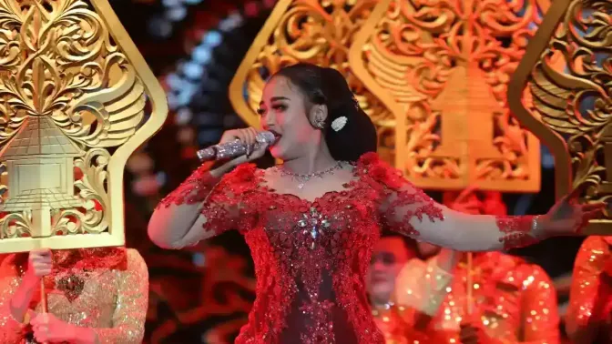 Panggung megah dengan backdrop Dies Natalis, confetti, lampu sorot, dengan bintang tamu Niken Salindri